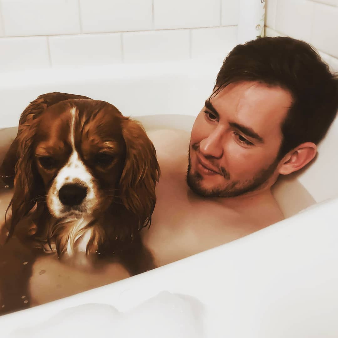CJ and Theo sitting together in a bathtub